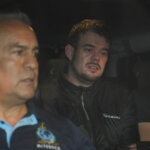 Joran van der Sloot is driven away from prison in a police vehicle.