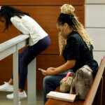 Olivia Caraballo, 8, and her mother, Philana Holmes, are shown in the courtroom gallery.