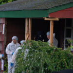 Crime laboratory officers arrive to the house where a suspect has been taken into custody on New York's Long Island
