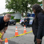 Police officers stand guard near the house where a suspect has been taken into custody on New York's Long Island