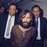 Charles Manson is escorted to his arraignment
