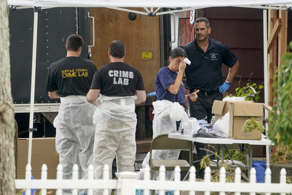 Authorities search the home of suspect Rex Heuermann.