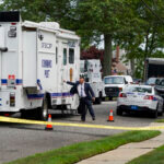 Authorities search the home of suspect Rex Heuermann.