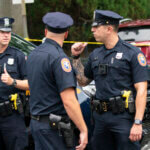 Police officers stand guard near the house where a suspect has been taken into custody on New York's Long Island