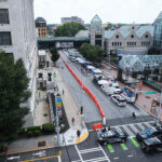Media vehicles stage outside the Fulton County Courthouse