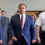 Suffolk County District Attorney Ray Tierney exits after a court