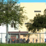 Nine members of Congress and others wait to enter Marjory Stoneman Douglas High School