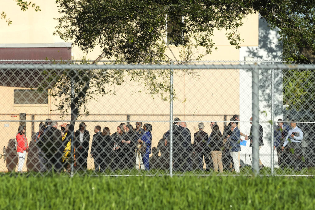 Nine members of Congress and others wait to enter Marjory Stoneman Douglas High School