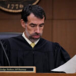 Fulton County Superior Court Judge Robert McBurney looks through paperwork