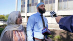 Adnan Syed walks with his mother.