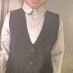 a young child in a suit
