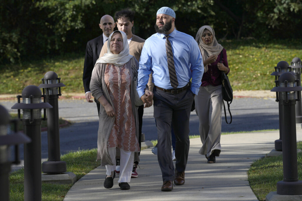 Adnan Syed walks with his mother.