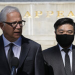 Attorney David Sanford, left, and Young Lee, right, brother of murder victim Hae Min Lee.