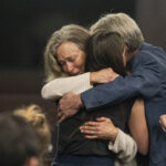 Parents of Anna Moriah Wilson, Karen Wilson and Eric Wilson, embrace Caitlin Cash, friend of Anna Moriah Wilso, following the sentencing portion of Kaitlin Armstrong's murder trial at the Blackwell-Thurman Criminal Justice Center on Friday, Nov. 17, 2023. Armstrong was found guilty of killing Anna Moriah Wilson in May 2022 and sentenced to 90 years in prison.