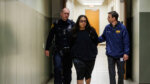 Christopher Preciado, center, is escorted by San Antonio Police