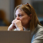 Michelle Troconis sits in court with her hands to her face