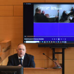 man sits in front of monitor