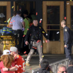 police and emergency crews walk around confetti