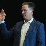 A man raises his hand to be sworn into court
