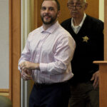 Adam Montgomery sticks out his tongue as he enters court