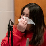 Kayla Montgomery wipes her eyes
