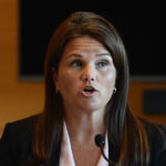 A woman testifies in court.
