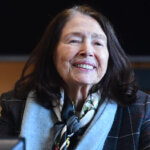 A woman smiles on the witness stand