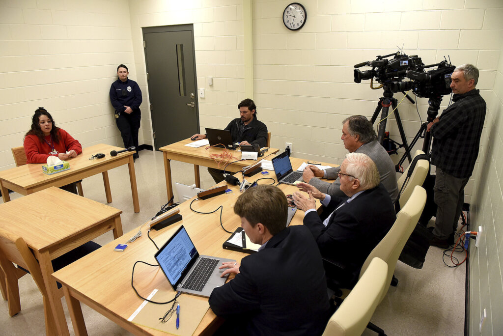 people on laptops sit at a table