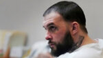 Adam Montgomery sits in court