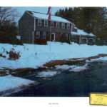 1/29/22 nighttime photo of 34 Fairview. Street in foreground with patchy snow in area where body was found.
