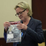 woman handles evidence bag