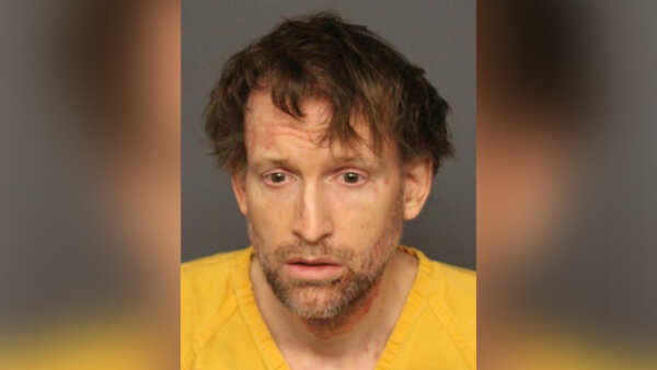 Professor formally charged after wife found next to deceased infant