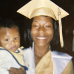 graduate holds baby