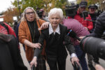 Joan VanderMolen, center, arrives at a courthouse