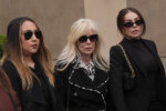 Tammi Menendez, center, the wife of Eric Menendez, leaves a courthouse