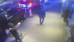 still from surveillance video shows man pointing gun at victim