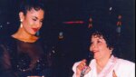 Selena, left, watches as Yolanda Saldivar speaks to a crowd