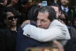 A$AP Rocky, center left, hugs attorney Joe Tacopina after he was found not guilty