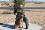 Border Patrol Agent David Maland posing with a service dog