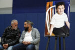 Wadee Alfayoumi's father, Oday Al Fayoume, seated right, and his uncle Mahmoud Yousef attend a vigil for Wadee