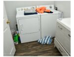 laundry room with towels, clothes on machines