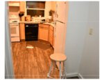 Hallway leads into kitchen