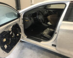white vehicle with door open