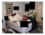Messy bedroom with purple sheets and black redacted squares