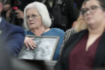 Debbie Dennison, grandmother to murder victim James Matthew Wilson, holds a portrait in court during a preliminary hearing for Austin Drummond