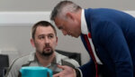 Defendant Austin Drummond, left, accused of quadruple murder, speaks to his attorney Jere Mason