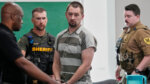 Defendant Austin Drummond, accused of quadruple murder, leaves the courtroom after a preliminary hearing