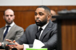 Sherrone Moore, center, appears in the courtroom