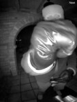 man in mask holds up fist