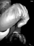 man in mask holds up fist
